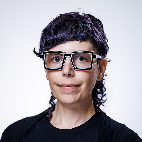 Headshot of person with black square classes and dark hair