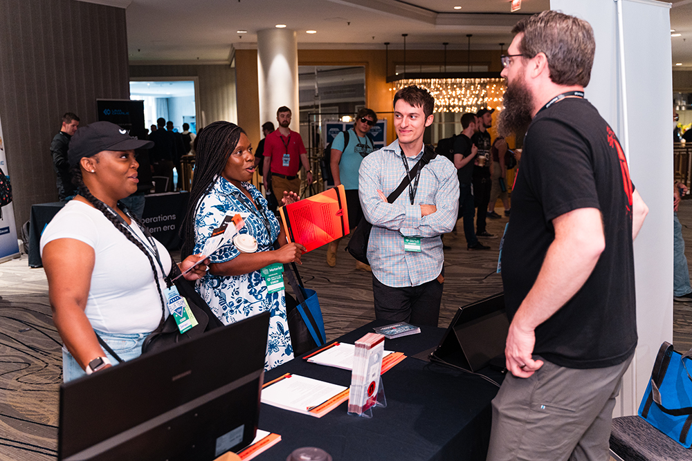 Blue Team Con Partner speaking with attendees